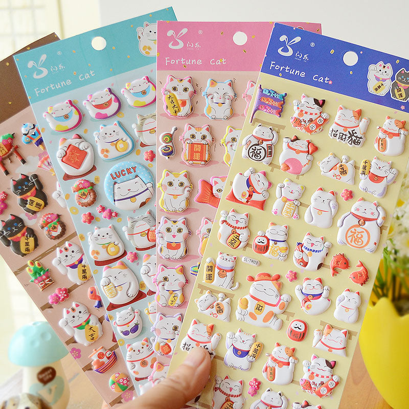 Adorable fortune cat cute paradise-themed 3D bubble gum stickers with lucky cat designs. Perfect for decorating phone cases, laptops & journals. Soft rubber kawaii stickers.