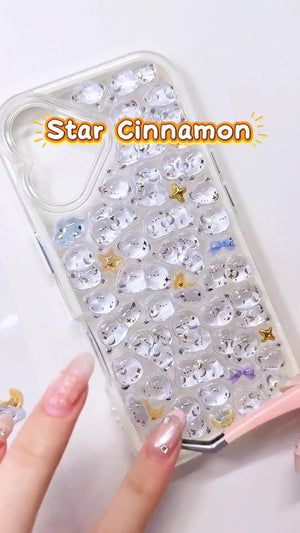 Handcrafted phone case with a cream white border, densely filled with a 3D collage of glossy, transparent long-tailed tit bird charms, golden stars, and miniature crescent moons.
