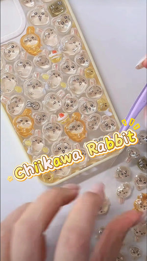 Handcrafted phone case with a creamy yellow border, densely filled with a 3D collage of glossy, transparent Chiikawa Usagi rabbit character charms and mini pudding treats.