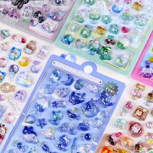 Close-up of BONBON DROP stickers with cute rabbit, bear & cat patterns, showing iridescent epoxy texture
