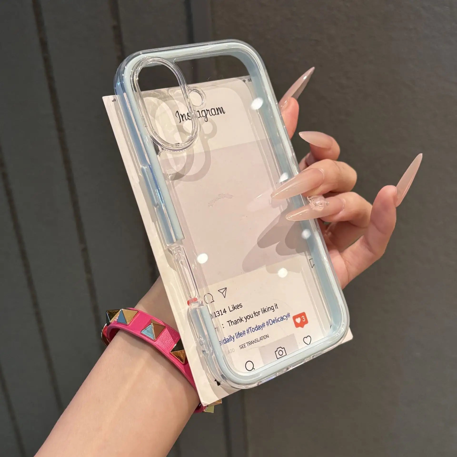 A minimalist clear baby blue acrylic bumper phone case with enhanced corner and camera protection, held in hand.