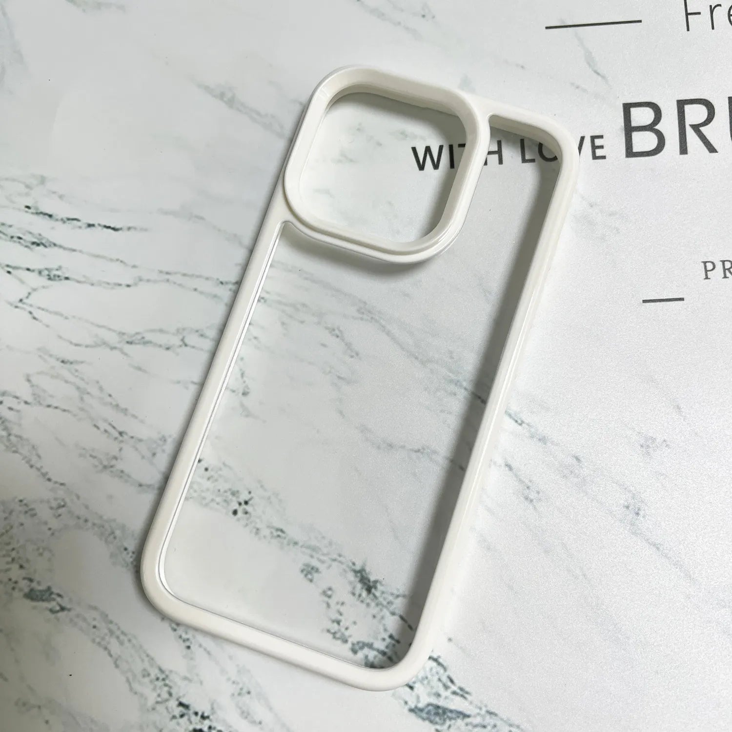 A minimalist hybrid protective phone case in cozy cream white featuring a thick raised wide bumper frame and a crystal clear transparent back panel.