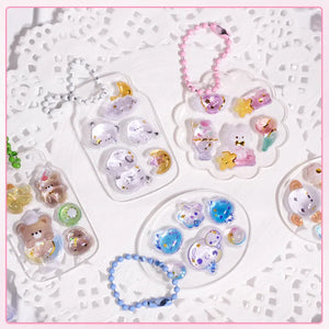 Decorative display of 3D crystal clear stickers with cute animal and celestial designs, used for keychain and DIY crafts