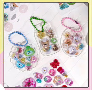 Decorative display of 3D crystal stickers used for keychain DIY, featuring cute animal and dessert designs, perfect for craft projects and gift making