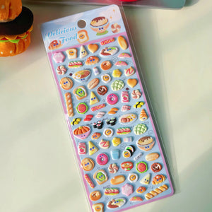 Delicious Food" cute kawaii sticker sheet in light blue tone, with glossy cartoon food designs (sushi, bread, donuts, etc.), ideal for craft decoration.