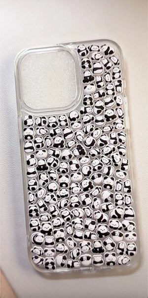 Finished DIY clear iPhone case decorated with dense mini panda stickers, featuring a cute minimalist black and white panda aesthetic.