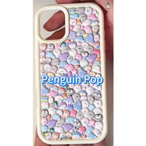 Finished DIY iPhone case with cream frame, decorated with dense mini positive energy penguin and sea animal stickers, featuring a soft pastel kawaii aesthetic.