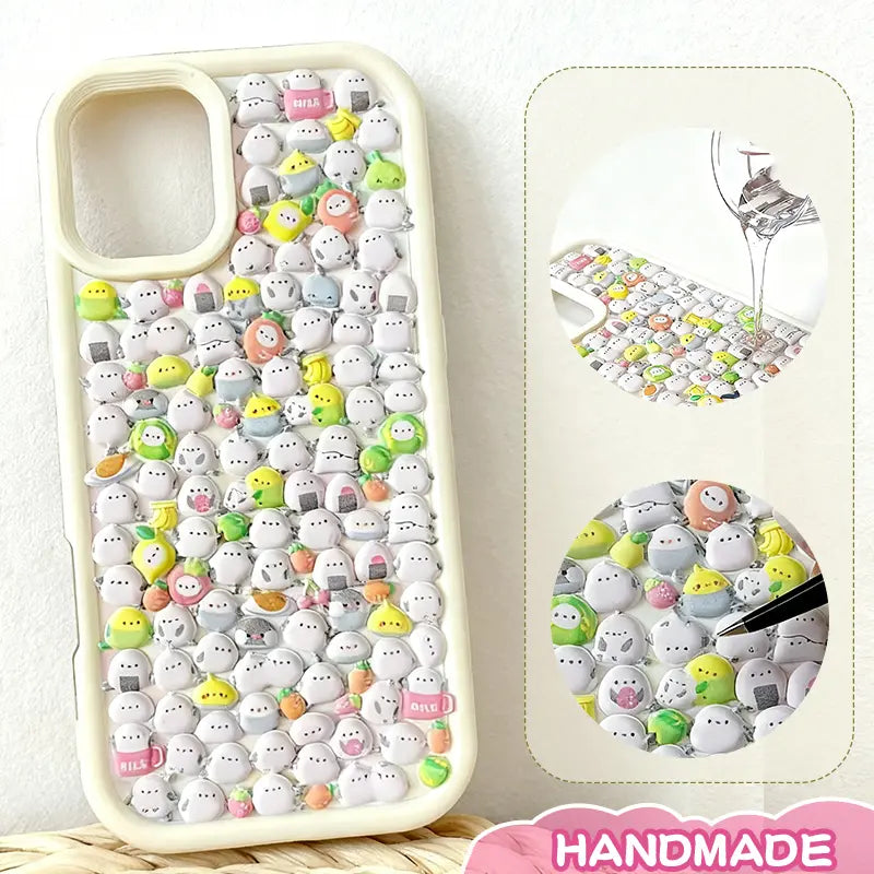 Finished display of handmade DIY phone case with full ghost creature print, creamy white frame, and cute mini character patterns