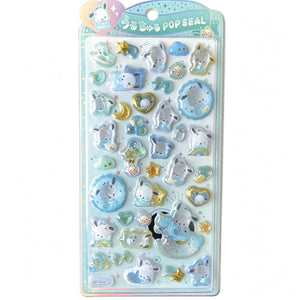 A retail package of official Pochacco Pop Seal 3D puffy stickers filled with shimmering star glitter, featuring cute cartoon puppy characters in blue and gold celestial themes.