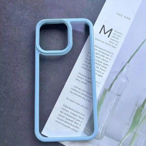 Clear DIY phone case for iPhone with light blue protective frame and transparent back panel, featuring raised camera protection, ready for sticker decoration.