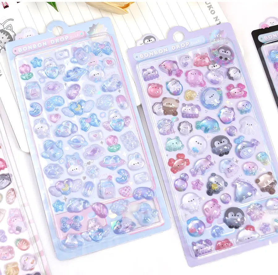 Collection of 3D crystal puffy "BONBON DROP" sticker sheets with adorable ocean pet designs, in pastel blue and purple color schemes