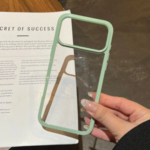 Minimalist pastel green contrast bumper phone case with a clear transparent back, held over a book background.