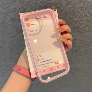 A minimalist hybrid protective phone case with a soft pastel pink border frame and a crystal clear transparent back panel, held in hand.