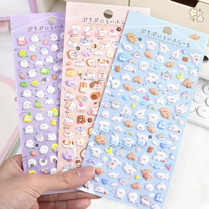 Handheld display of 3 Puchipuni Life Seal sticker sheets (blue/pink/purple), cute animal & food designs