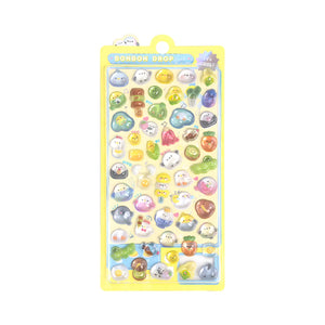 Full display of "BONBON DROP" 3D crystal puffy sticker sheet with yellow packaging, showcasing cute dinosaur, chick, and fruit designs with iridescent effects