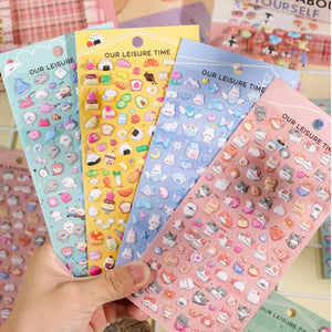 Handheld display of 4 styles of 3D embossed bubble stickers (sushi, dessert, blue rabbit, cat), cute pastel patterns, PVC self-adhesive