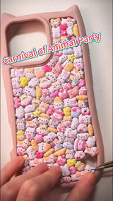 Handcrafted phone case with a pastel pink cat-ear shaped border, densely filled with a 3D collage of glossy cartoon kitten charms, pink donuts, and mini cat paw details.
