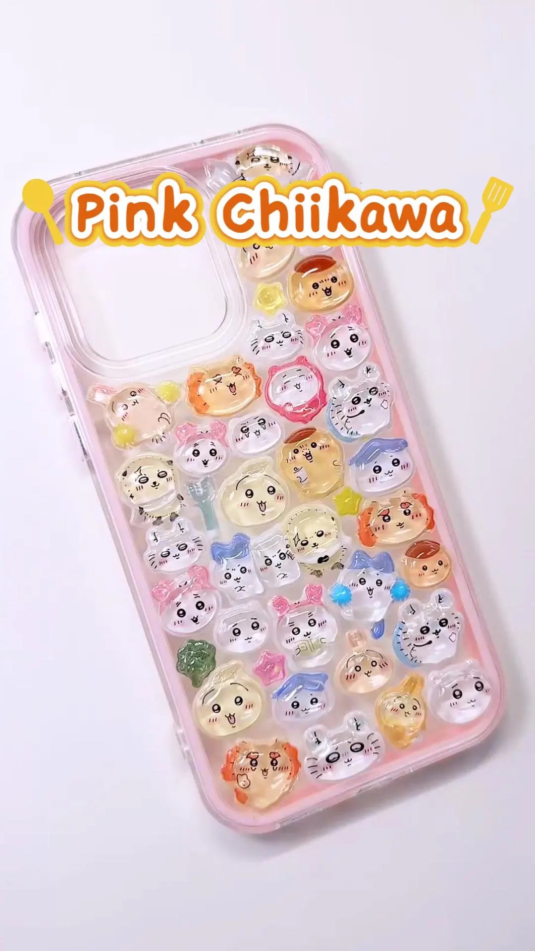 Handcrafted phone case with a soft pastel pink border, densely filled with a 3D collage of glossy, transparent Chiikawa, Hachiware, and Usagi cartoon character charms.