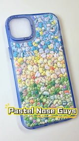 Handcrafted phone case with a pastel ice blue border filled with a dense 3D collage of glossy, transparent Mt. Fuji, travel buses, sundaes, and cute rice ball charms.