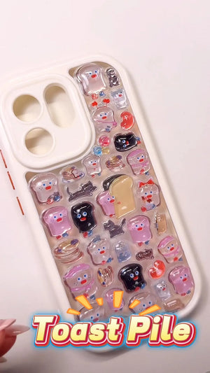 Handcrafted phone case with a cream off-white border filled with a dense 3D collage of glossy, transparent cartoon toast slices, pancakes, and cute black cat charms.