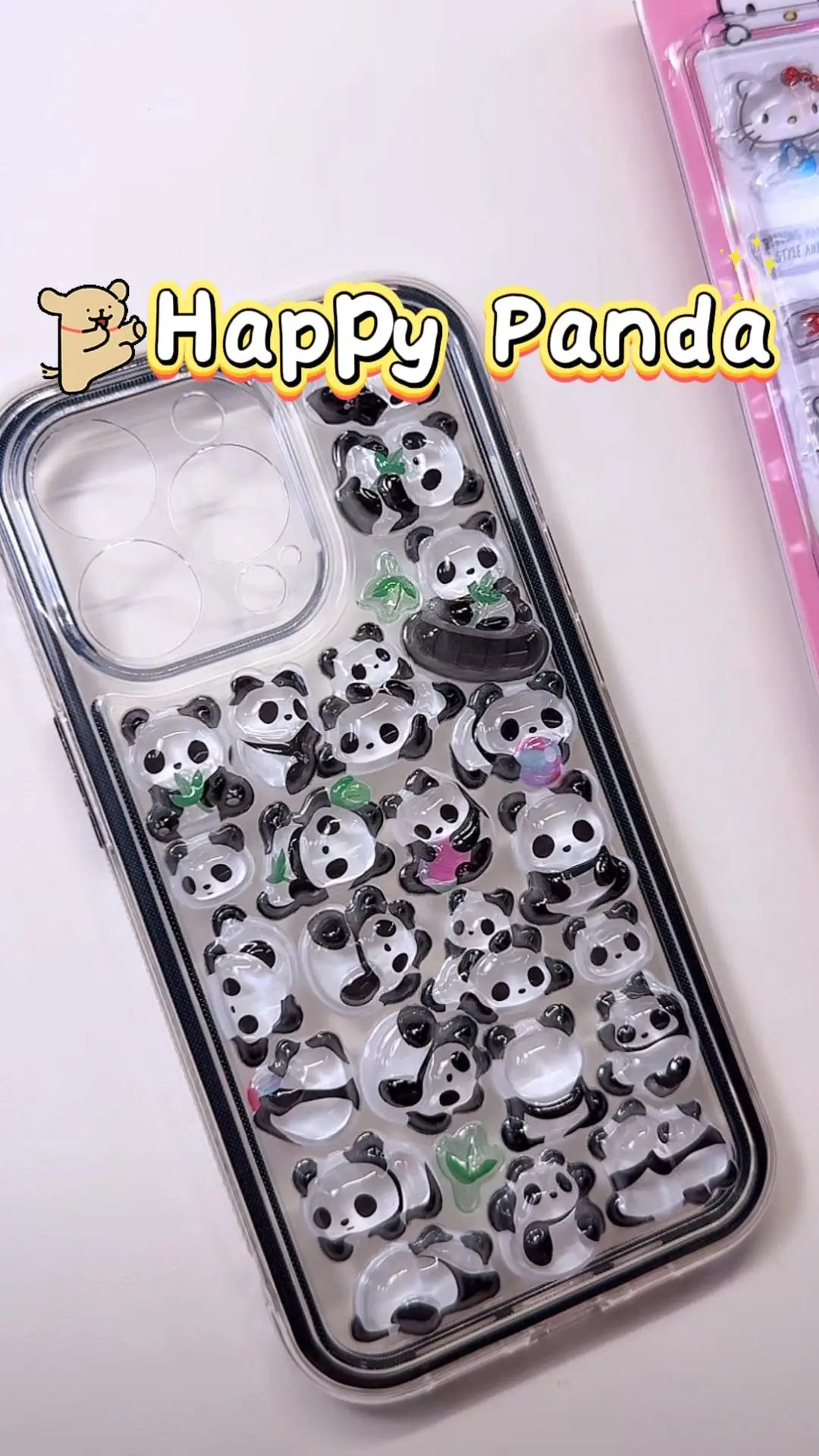 Handcrafted phone case with a clear black border filled with a dense 3D collage of glossy, transparent cartoon giant panda charms and green bamboo leaves.