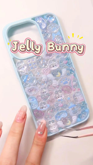 Handcrafted clear phone case with a light blue wide border, densely filled with a 3D collage of glossy, holographic aurora rabbit charms, milk boxes, and cat paw details.