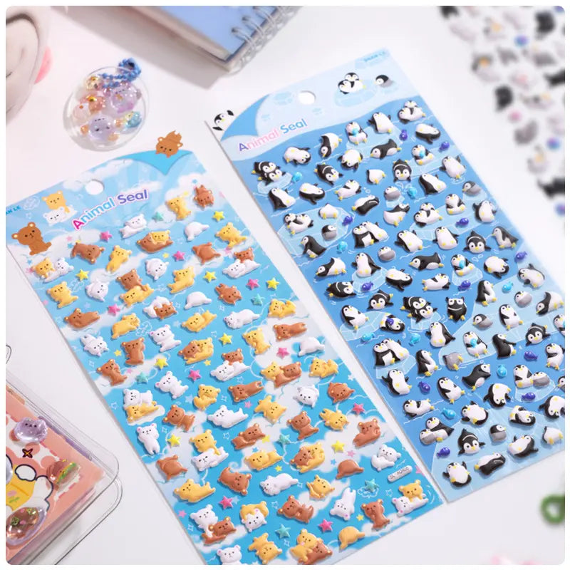 Handheld display of 2 sheets: penguin & corgi/cat 3D bubble stickers, blue background, PVC self-adhesive	
