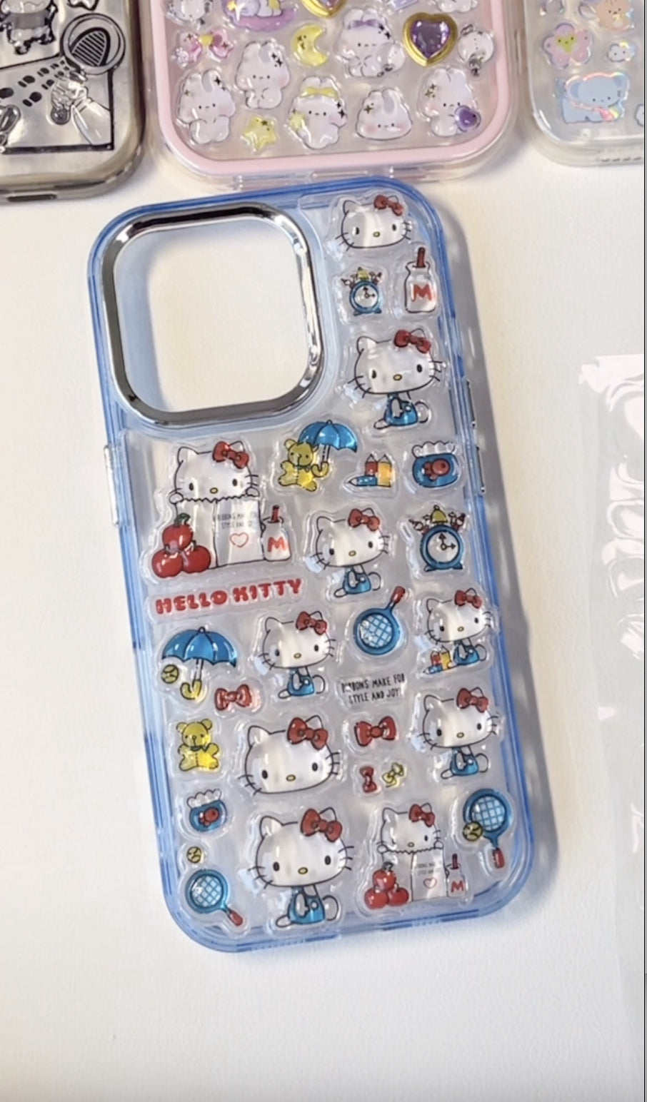 Adorable handmade Hello Kitty blue clear iPhone case. Unique kawaii Sanrio design featuring 3D epoxy stickers. Premium quality custom phone case for Hello Kitty fans.