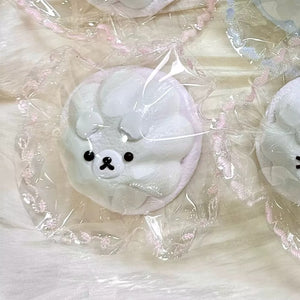 White pudding-shaped squishy with a bear face in clear packaging.