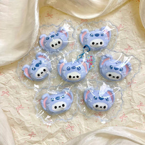 Several white bunny faces wearing blue character hoods, each in clear packaging.