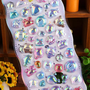 Close-up of 3D crystal clear "BONBON DROP" stickers with adorable iridescent pet and sea creature designs, featuring holographic and glitter effects, self-adhesive PVC epoxy stickers