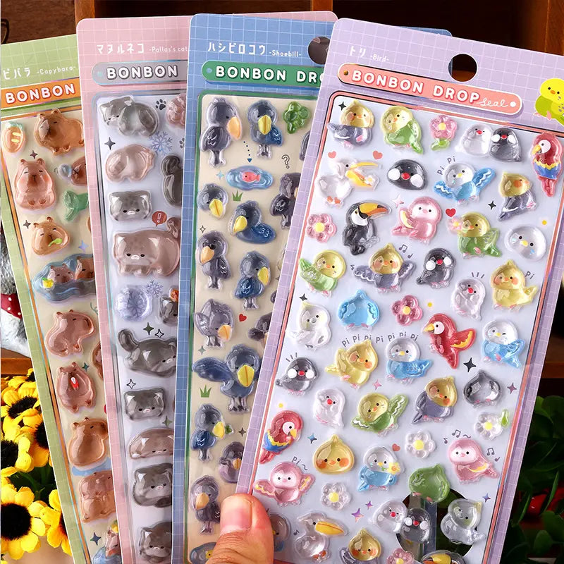 Collection display of 4 BONBON DROP 3D crystal sticker styles (capybara, cat, shoebill, bird), cute animal designs	