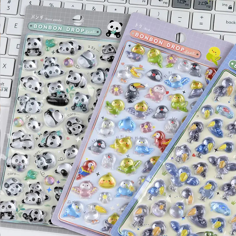 Desk display of multiple BONBON DROP 3D crystal sticker sheets (panda, bird, shoebill)	