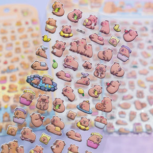 Close-up of 3D puffy Capybara stickers, highlighting cute capybara motifs with hot spring, fruit, and daily life elements, self-adhesive PVC stickers

