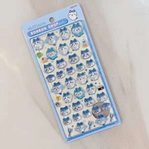 An official style sheet of Chiikawa Bonbon Drop Seal 3D puffy stickers featuring various cute expressions of Hachiware cat.