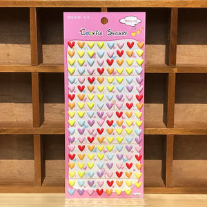 Display of "Colorful Sticker" 3D puffy colorful heart stickers, featuring pastel heart designs in red, yellow, blue, and pink, ideal for romantic DIY projects.