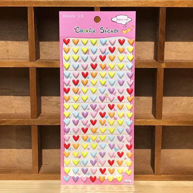 Display of "Colorful Sticker" 3D puffy colorful heart stickers, featuring pastel heart designs in red, yellow, blue, and pink, ideal for romantic DIY projects.