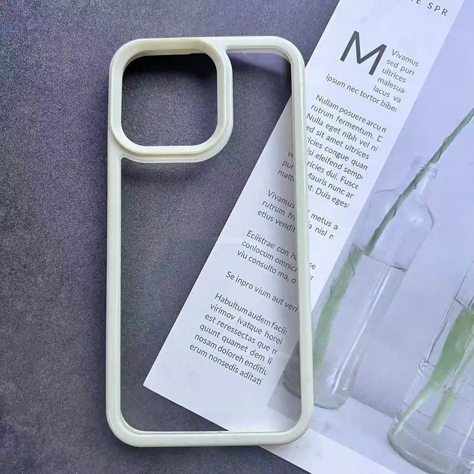 Clear DIY phone case for iPhone with cream-colored protective frame and transparent back panel, featuring raised camera protection, ready for sticker decoration.