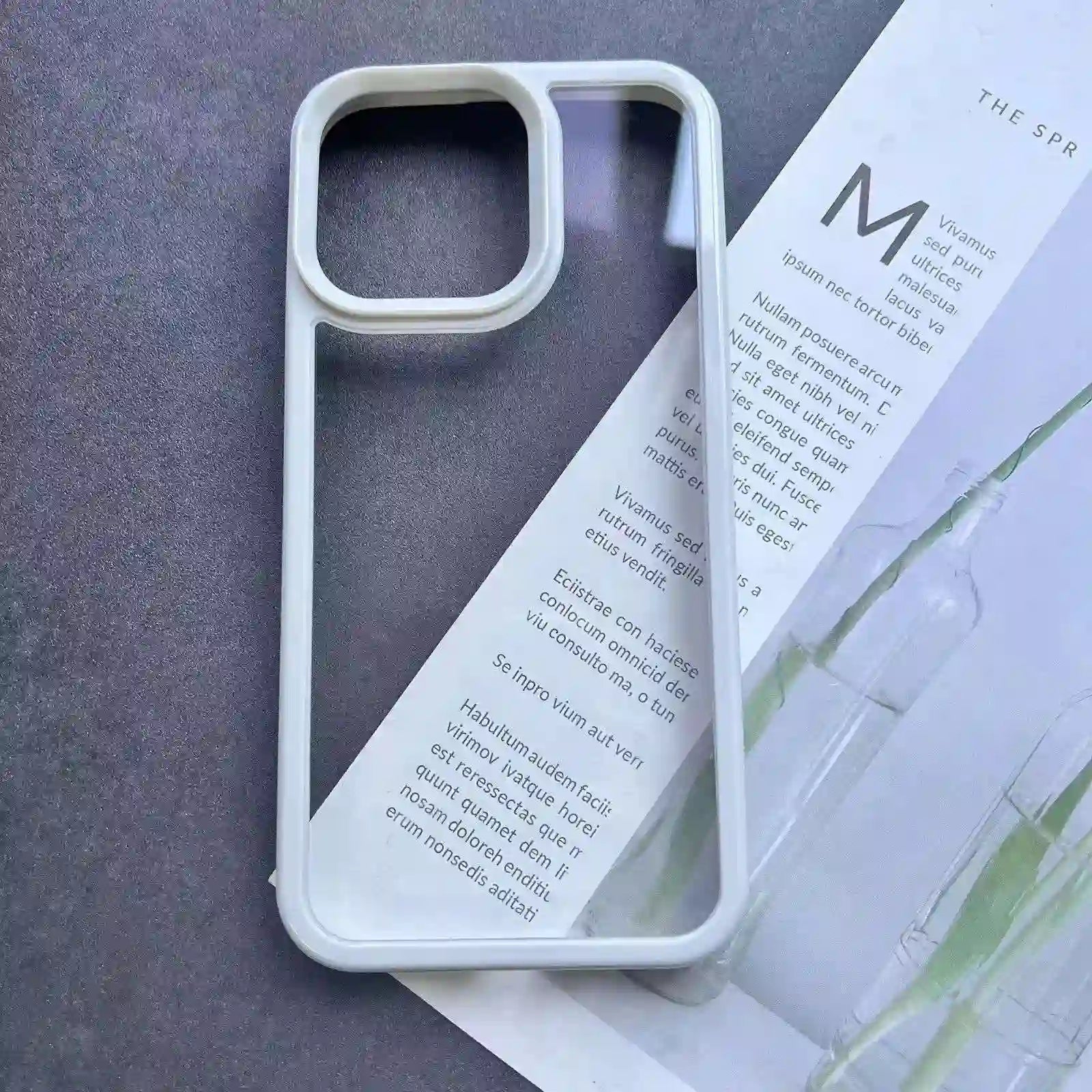 Clear DIY phone case for iPhone with cream-colored protective frame and transparent back panel, featuring raised camera protection, ready for sticker decoration.
