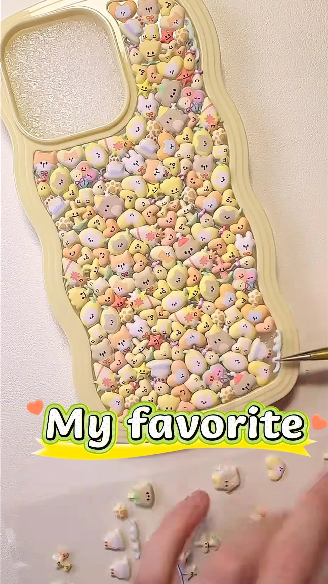 Handcrafted cream yellow wavy frame 3D phone case filled with a dense, colorful collage of cute squishy cartoon animals and hearts.