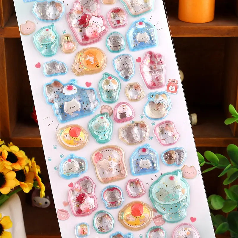 Close-up of 3D crystal clear dessert cat stickers with adorable cat and sweet treat designs, featuring iridescent and glitter effects, self-adhesive PVC epoxy stickers