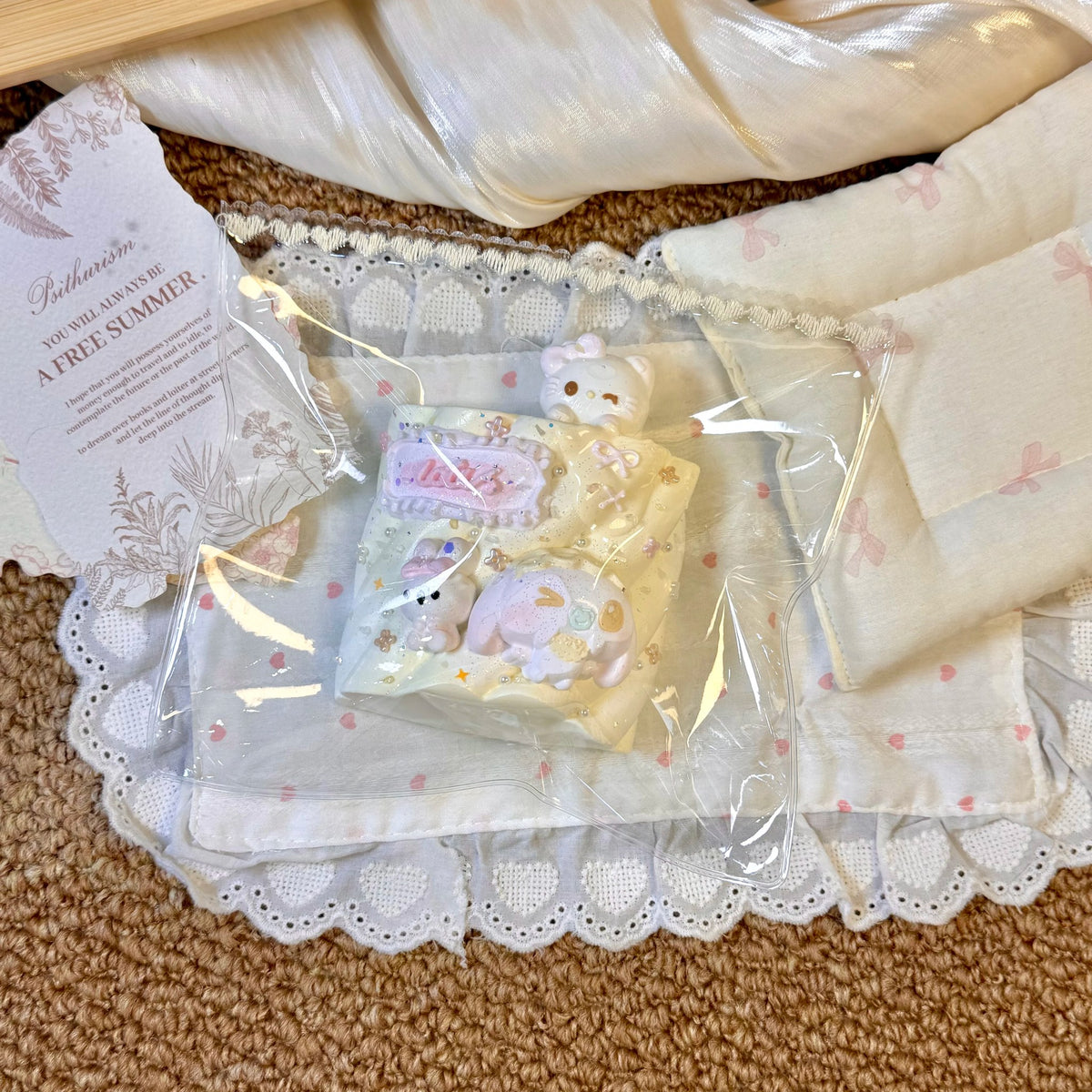 Small pastel cat and dessert shapes arranged together in clear packaging.