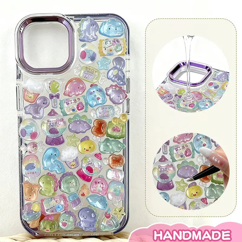 Finished display of handmade DIY phone case decorated with 3D crystal pet stickers, featuring cute animal and candy designs with iridescent effects