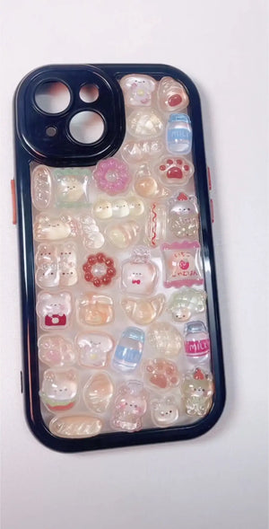 Finished DIY iPhone case with glossy black frame, decorated with glossy Bonbon Drop bread, dessert, and bear stickers, featuring cute jelly-style designs.