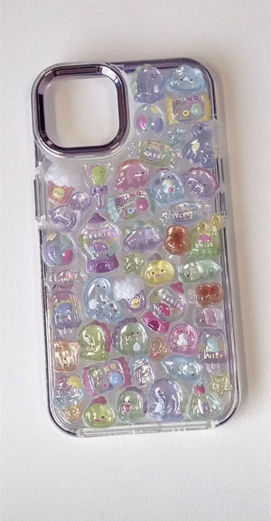 Finished DIY iPhone case with purple frame, decorated with glossy Bonbon Drop candy and dinosaur stickers, featuring pastel colors and cute jelly-style designs.