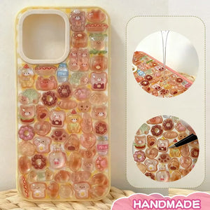 Finished DIY iPhone case with cream yellow frame, decorated with dense glossy bread and bear stickers, creating a warm bakery aesthetic.