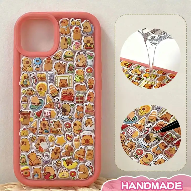 Finished DIY iPhone case with coral orange frame, decorated with dense capybara and food stickers, creating a warm cozy capybara paradise aesthetic.
