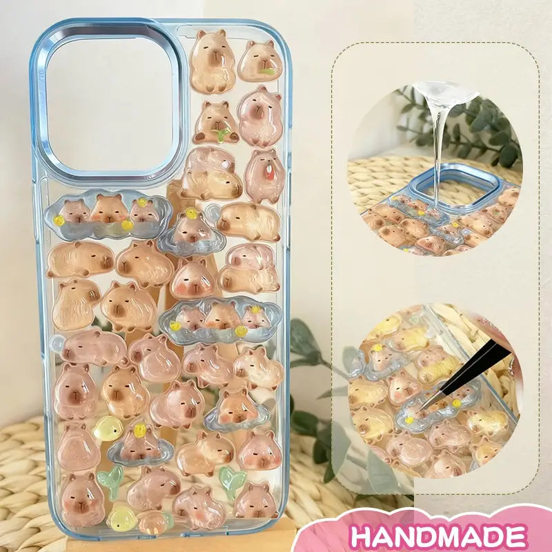 Finished DIY iPhone case with gradient blue frame, decorated with dense glossy capybara stickers, creating a warm and cozy capybara paradise aesthetic.