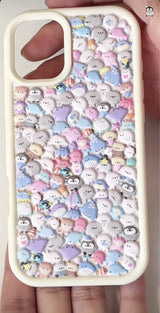 Finished DIY iPhone case with cream frame, decorated with dense 3D cute sea creature stickers, including seals, penguins, and other kawaii marine animals in pastel colors.
