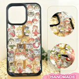 Finished DIY iPhone case with black frame, decorated with dense glossy fruit-themed cat stickers, creating a cute and fresh aesthetic.
